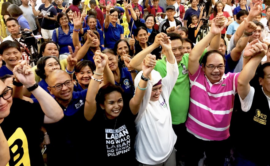 Opposition senatorial candidates known as "Otso Diretso" or the "Straight Eight" take a group photo with a crowd of civic leaders inside the St. Ferdinand Cathedral in Lucena, Philippines.