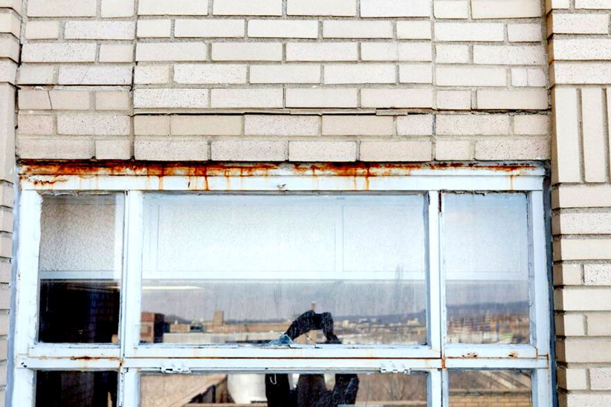 This image from before work began shows rusted window frames and failing brick work prevalent around the building.