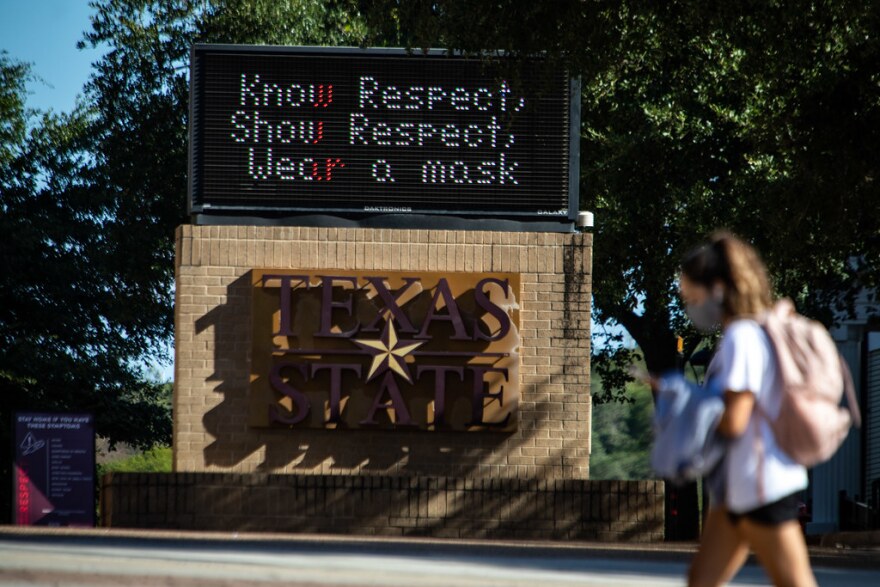 A Texas State student walks on campus at the start of the fall semester.