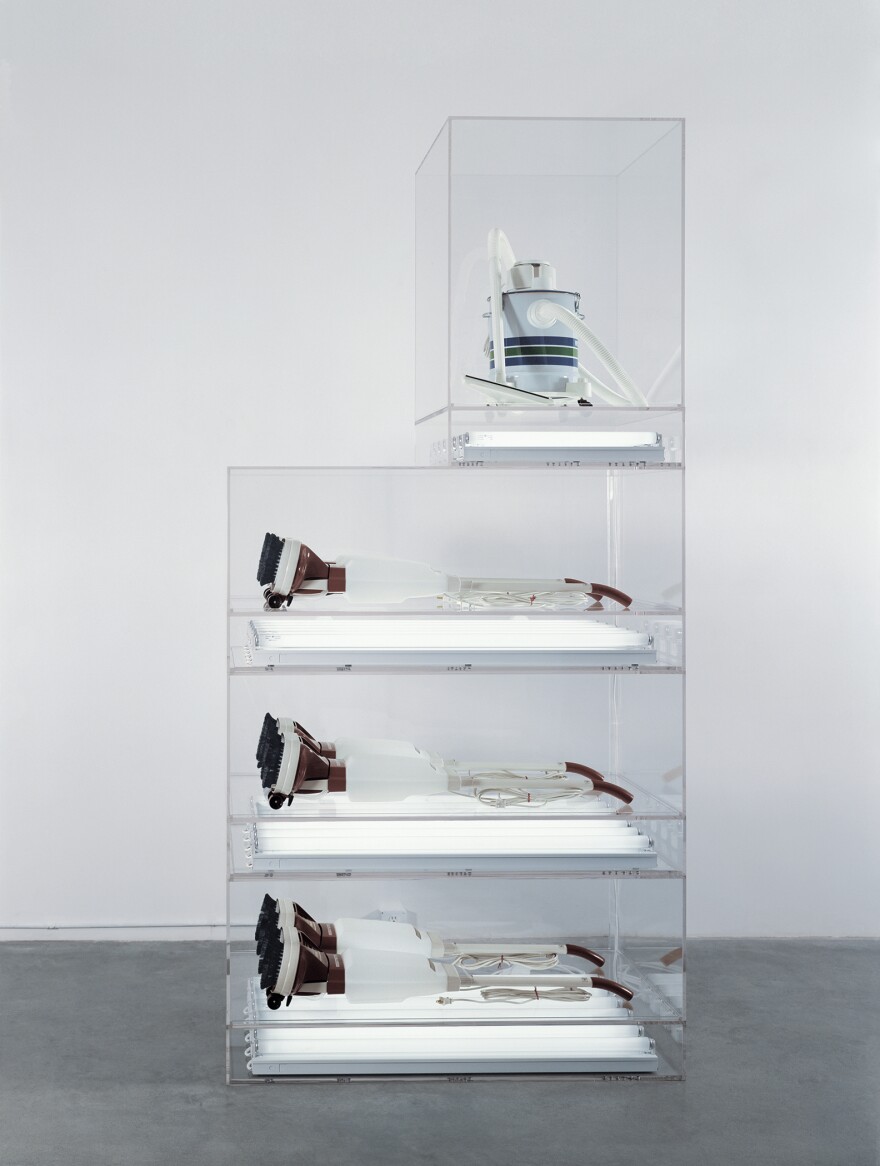 What's a vacuum cleaner doing in an art museum? A visitor services associate can answer that question about Jeff Koons' <em>New Hoover Deluxe Shampoo Polishers, New Shelton Wet/Dry 5-Gallon Displaced Quadradecker. </em>"I think it's an interesting concept and, in a way, it goes back to anthropology," explains Celia Lopez.