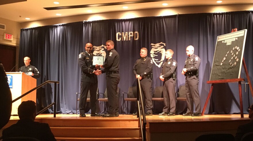 One of the class's 30 recruits accepts his law enforcement certificate.