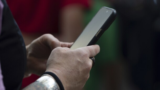 Someone's hand holds a phone.