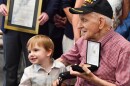 Sgt. Joseph Drake was honored in a ceremony at the Wayne County Courthouse for receiving the Congressional Gold Medal. He is one of only five surviving World War II Army Rangers. He holds his great-grandson, Everett Rotella, 3.