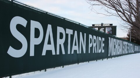 "Spartan Pride" fence in the snow near the MSU football stadium.