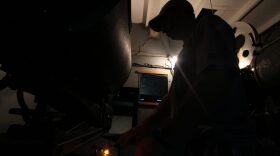 Alan Alligood turns on the Priest Theatre's film projection unit, which will soon be replaced by a digital version.