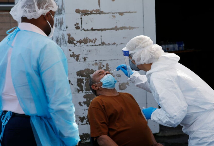 A nurse administers a coronavirus test at a COVID-19 testing site set up by Harvard Street Neighborhood Health Center at Prince Hall Grand Lodge in Grove Hall in Dorchester on Oct. 22, 2020. (Jessica Rinaldi/The Boston Globe via Getty Images)