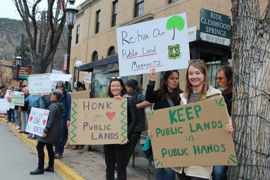 Signs held by attendees of a rally in Glenwood Springs read, "