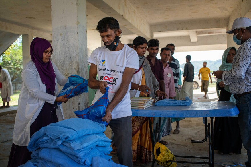 Bed nets treated with insecticide to ward off mosquitoes are distributed in Chakaria, Cox's Bazar, Bangladesh.