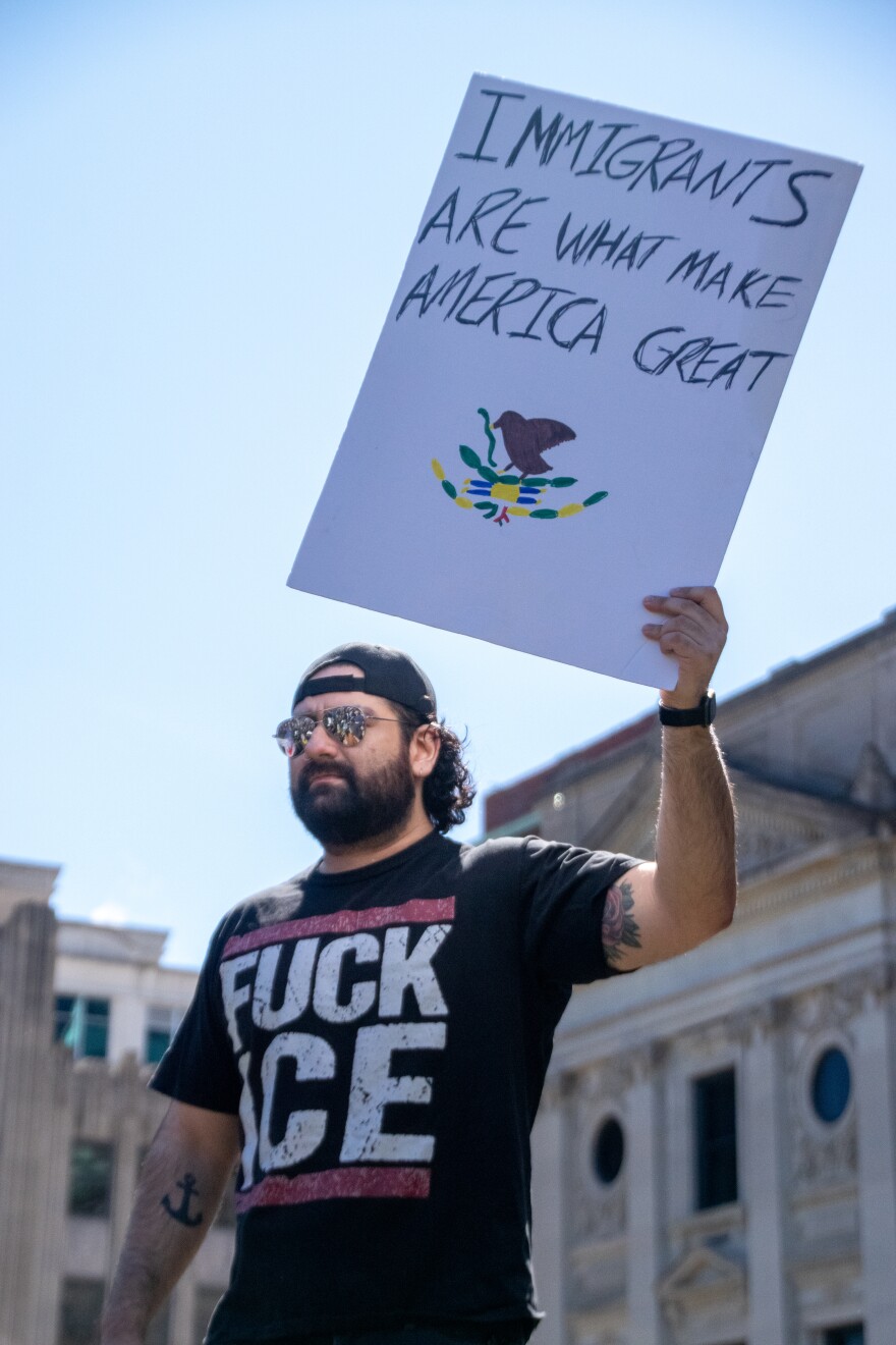 Ella AbbottOne protester stands on top of one of the fountains on the Allen County Courthouse green on Saturday with a sign that reads 'immigrants are what makes America great.' Many protests have seen an uptick in anti-ICE sentiment since the mass mobilization of the organization earlier this year.