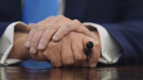 President Donald Trump holds a pen as he speaks to reporters as he signs executive orders in the Oval Office of the White House, Tuesday, Feb. 4, 2025, in Washington. (AP Photo/Evan Vucci)