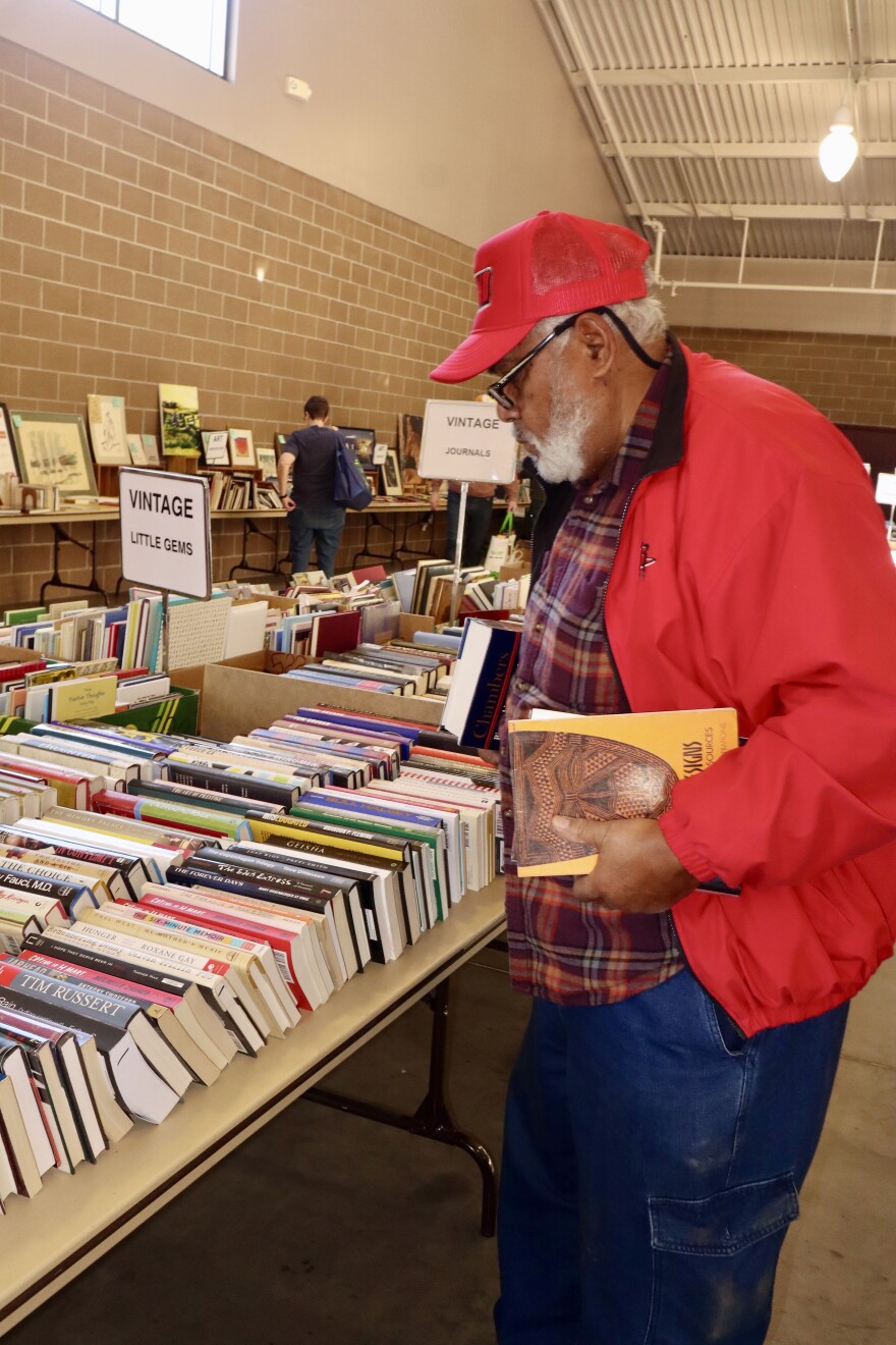 Book sale visitor Cortez Nichols bought several books from the sale on Nov. 7, 2025, including a biography about musician Quincy Jones.