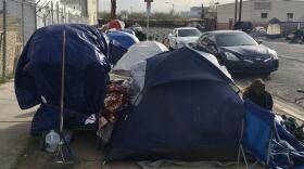 woman sitting outside tent