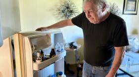 69-year-old Lee Rosen looks into his refrigerator. (Peter O'Dowd/Here & Now)