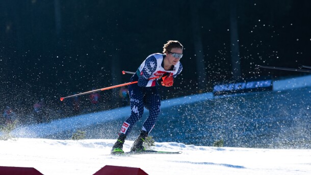 An action shot of a cross-country skier racing through the snow.