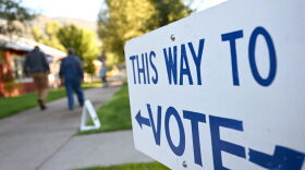 A sign reading "This Way To Vote" is displayed outside the Old Wilson Schoolhouse Community Center in Wilson, Wyoming as Wyoming holds its Republican primary election.