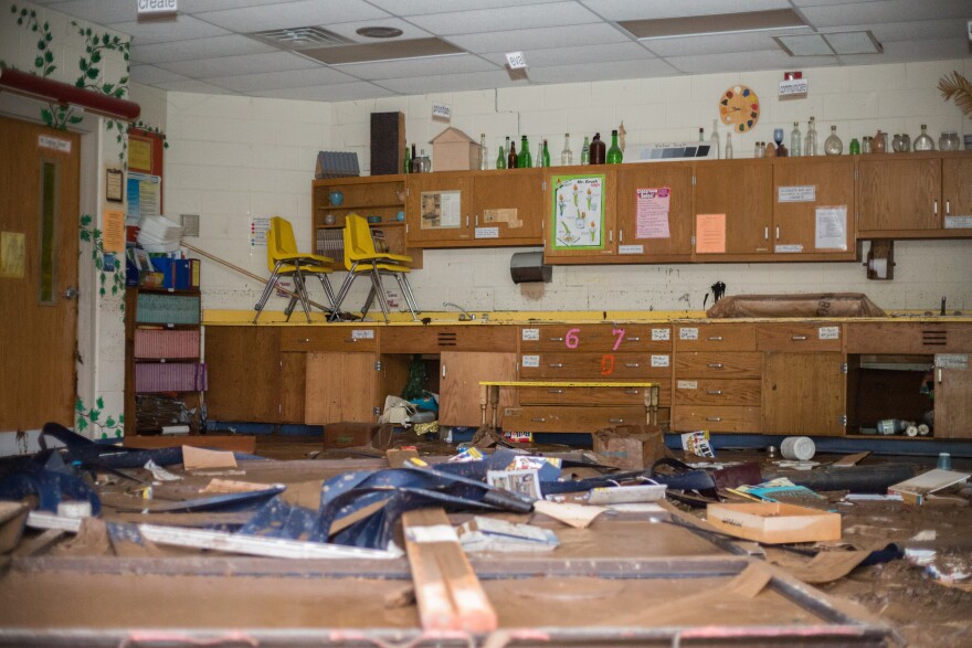 Debris covers the floor of the Richwood Middle School art room. Floodwaters completely blew out the large glass window exposing the classroom to the outdoors.