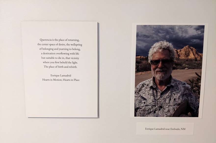 A photo of Enrique LaMadrid in the exhibition, accompanied by an excerpt from a poem he wrote about querencia.
