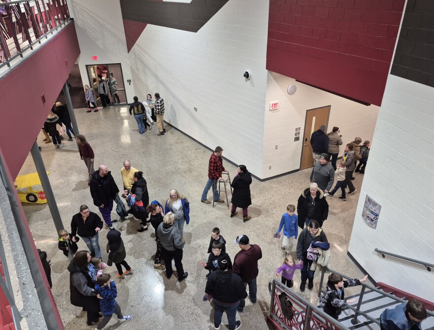 Parents and students walk around Western Elementary School during an open house.