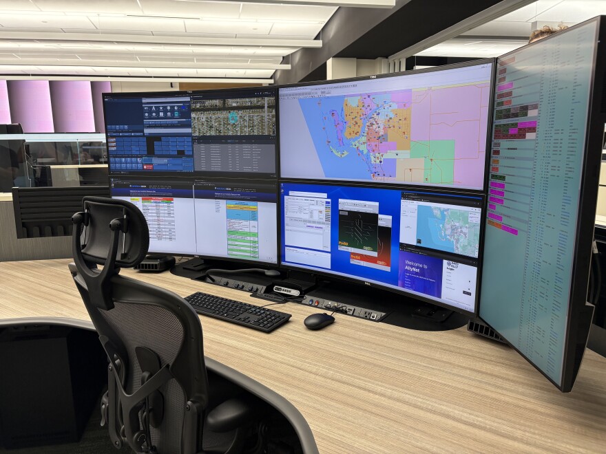 At the new Lee Public Safety Center, emergency telecommunicators, like 911 operators, are given a workstation with five computer monitors and an elevating desk. (Emma Rodriguez/WGCU)