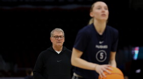 Head coach Geno Auriemma of the Connecticut Huskies looks on as Paige Bueckers #5 shoots during an open practice ahead of the 2024 NCAA Women's Basketball Tournament Final Four at Rocket Mortgage Fieldhouse on April 04, 2024 in Cleveland, Ohio. 