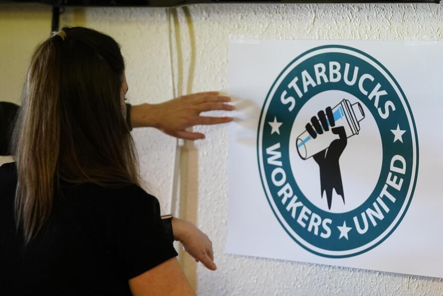 Michelle Eisen, a barista at the Buffalo, N.Y., Elmwood Starbucks location, helps out the local Starbucks Workers United, employees of a local Starbucks, as they gather at a local union hall to cast votes to unionize or not, on Feb. 16, 2022, in Mesa, Ariz. With an appeal request by Starbucks rejected. workers at one of the coffee giant's Mesa, Arizona, locations will vote Friday, Feb. 25, 2022, on whether or not to unionize. If the union wins out, it would be one of the first aside from two stores in Buffalo, New York, to organize.