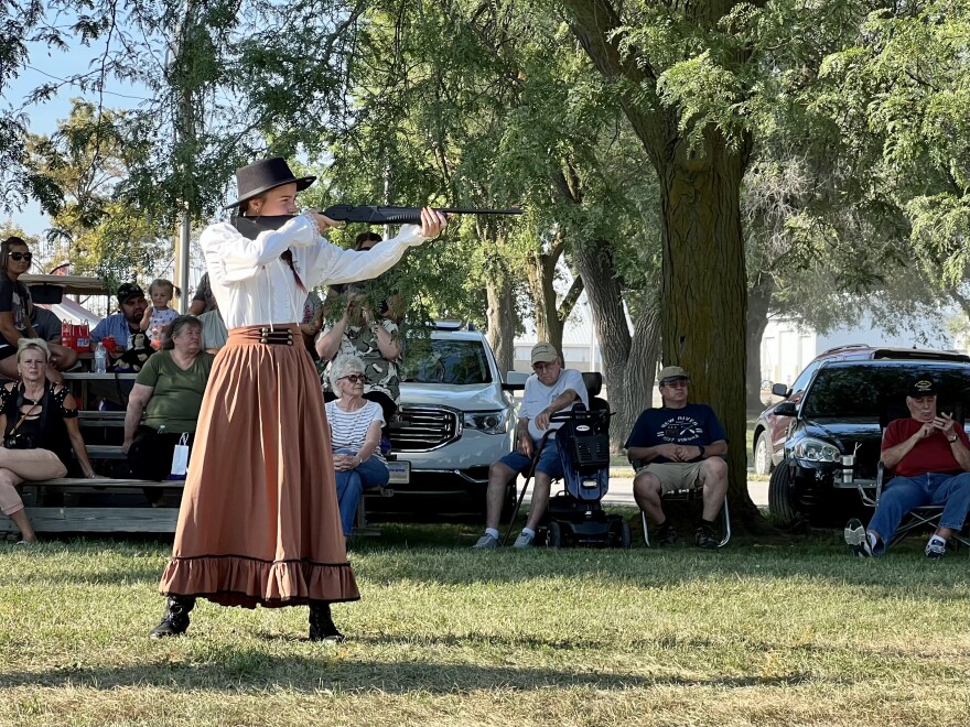 Alia Hunt aims her BB gun at a red balloon at the "Miss Annie Oakley" sharpshooting competition in Greenville.