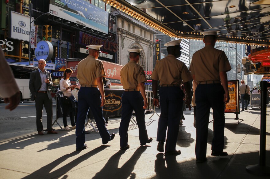 Marines walk around Times Square during Fleet Week in New York City last year. A Pentagon investigation is underway into the posting of hundreds, and perhaps thousands, of nude photos of female Marines.