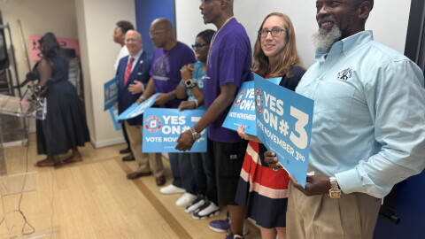 Kelvin Manurs, right, joins with Senator Elizabeth Bennett-Parker and other supporters of Amendment 3 at a press conference in Alexandria Tuesday.