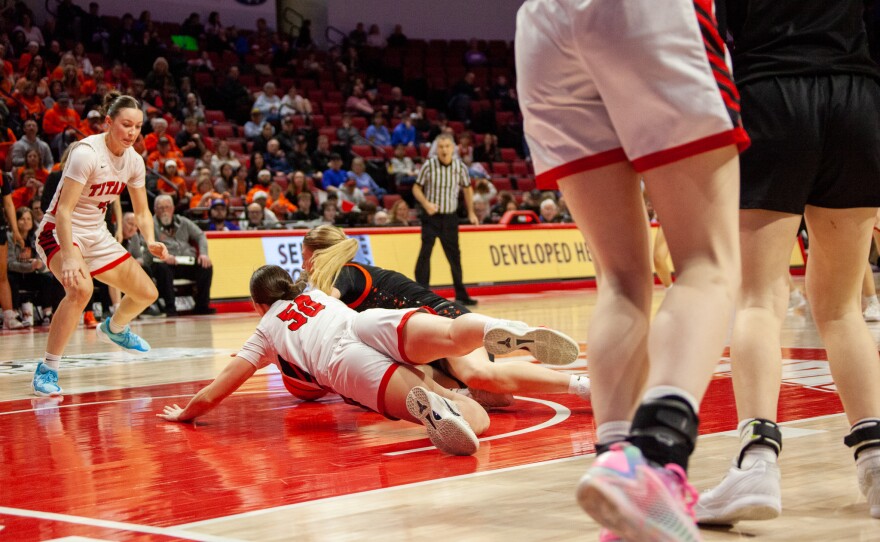 Girls high school basketball players inside an arena