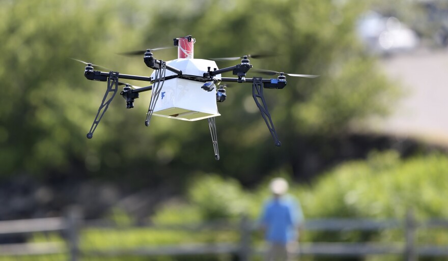 A drone aircraft with a payload of simulated blood, and other medical samples flies during a delivery simulation Wednesday, June 22, 2016, in Lower Township, N.J. (AP Photo/Mel Evans)