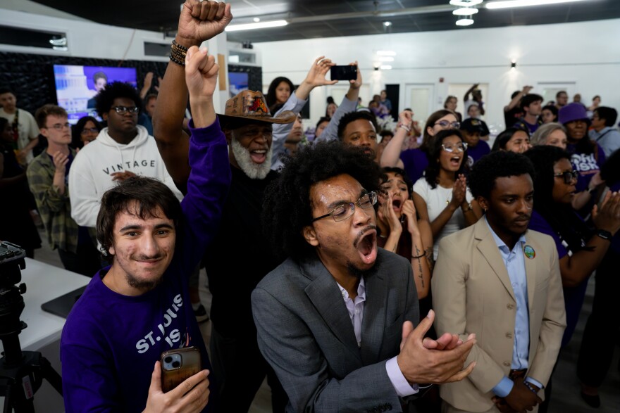 Darren Ross, a volunteer with Cori Bush's congressional campaign, at center, joins supporters rallying with the former congresswoman after Rep. Wesley Bell, D-St. Louis County, defeated her.