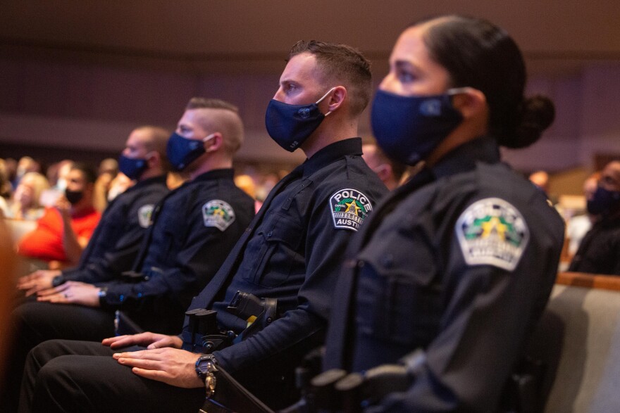 A line of police cadets seated during their graduation ceremony.