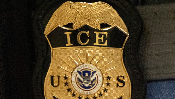 FILE - A federal agent wears an Immigration and Customs Enforcement badge in New York, June 10, 2025.