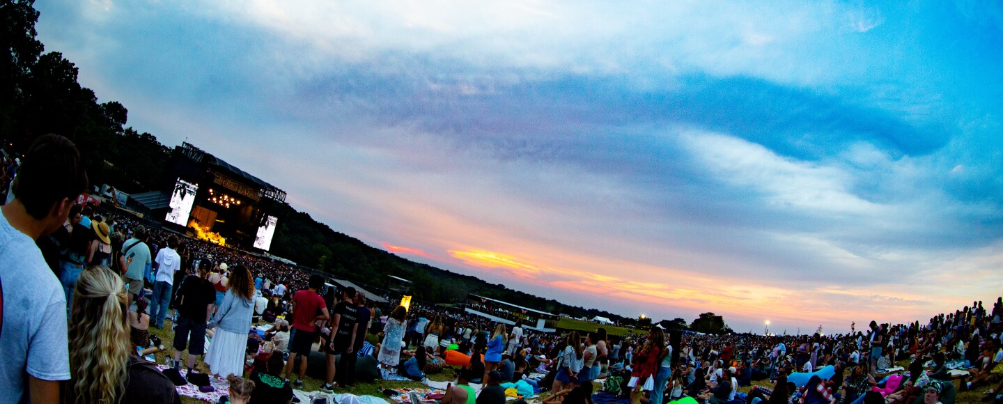 a large crowd of people watching a musical performance 