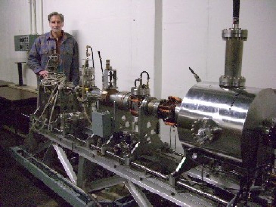 Dr. William Colson stands next to a component of the Free Electron Laser recently acquired by the Naval Postgraduate School.