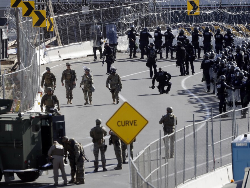 Military personnel and Customs and Border Protection officers gather at the San Ysidro Port of Entry in San Diego. The number of immigrants in the U.S. without legal status has declined to its lowest level in more than a decade, according to a new report released Tuesday.