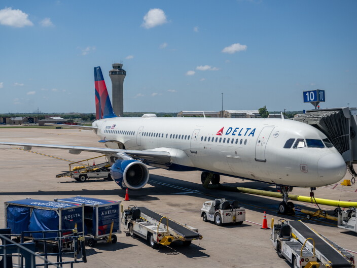 A Delta Airlines plane is seen waiting at an airport.