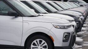 A long row of unsold 2021 Souls sits at a Kia dealership Sunday, Dec. 20, 2020, in Centennial, Colo. (AP Photo/David Zalubowski)