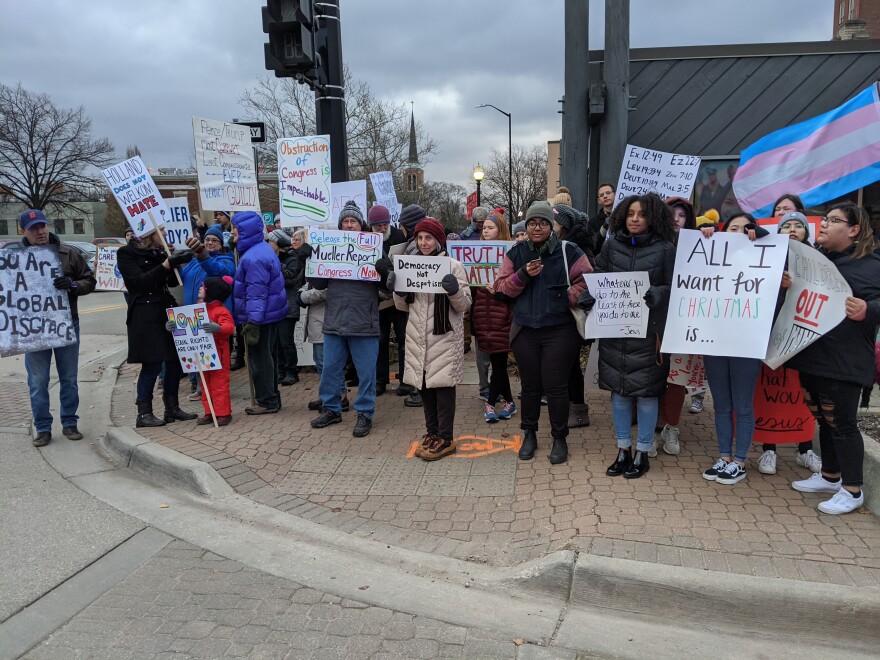 Protesters holding signs on corner