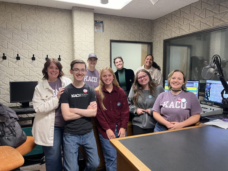 KACU General Manager and News Director Heather Claborn, left, poses with some of the station's student staff.
