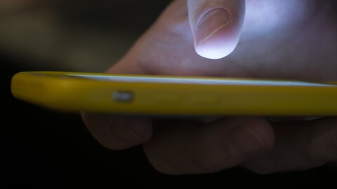 A man uses a cell phone.