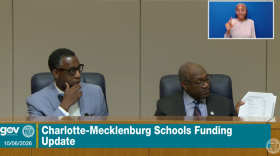 Mecklenburg Commissioners Mark Jerrell (left) and Arthur Griffin discuss the county's role in asking questions of CMS