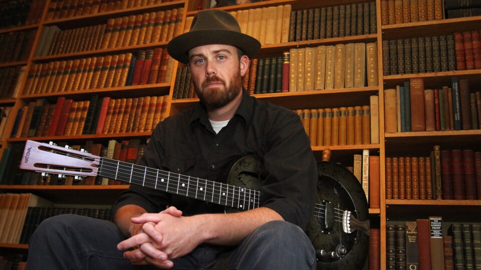a man posing with a guitar