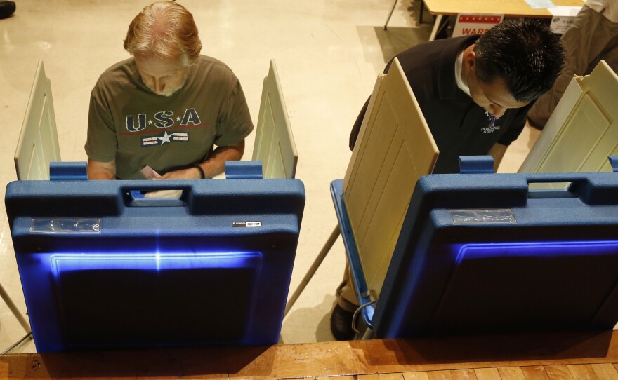 Voters cast ballots in Milwaukee. Critics of the governor gathered more than 900,000 signatures in support of the recall.