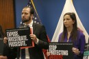 Rep. Abdelnasser Rashid and Rep. Anne Stava hold signs promoting the Illinois Epstein Files Investigation Act at a news conference in downtown Chicago on March 2, 2026.