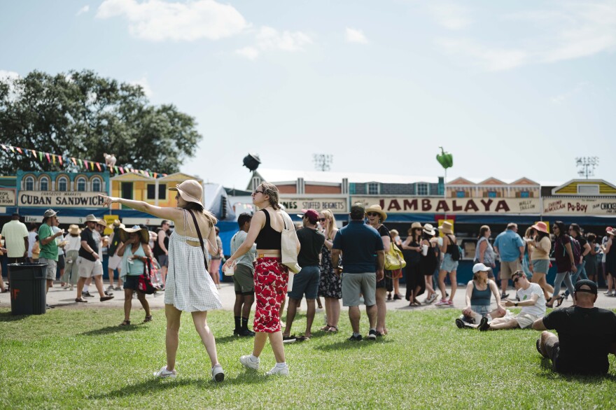 Festival goers survey the plethora of food and beverage options at the New Orleans Jazz and Heritage Festival on April 29, 2022. The festival made its return to the Fair Grounds Race Course after three years due to pandemic-related cancellations and reschedulings.
