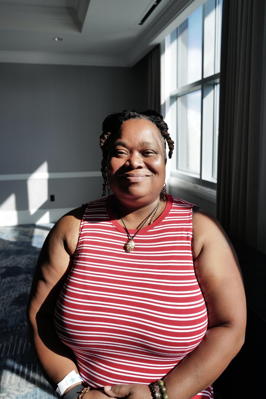 Nataki Hill stands in a conference room during a joint meeting of doulas and community health workers in Portsmouth.