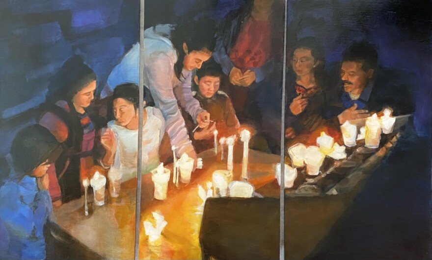 A painting called "Memorias" with people gathered in candlelight