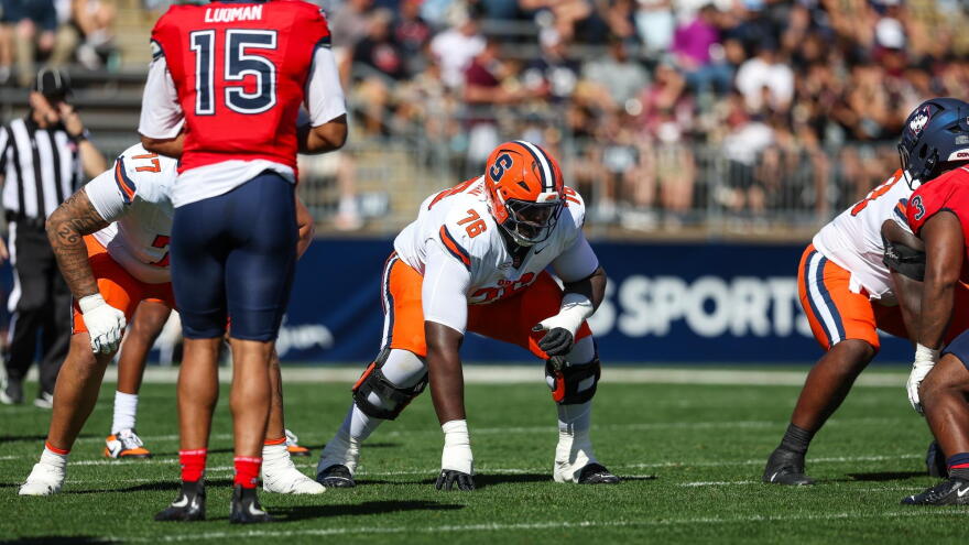 Syracuse offensive lineman Byron Washington (76, White) lines up for the snap.