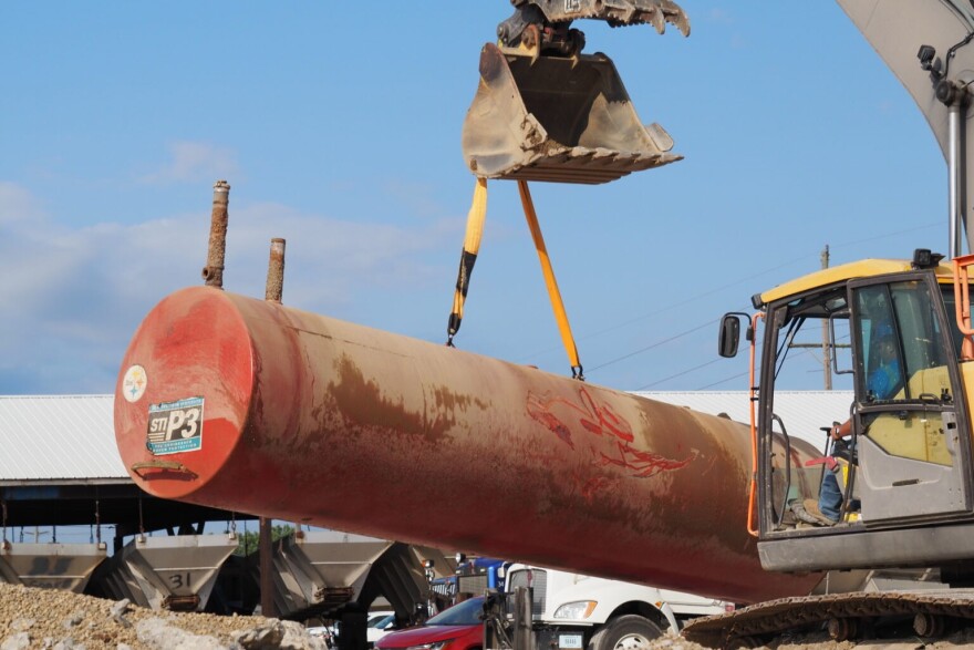 An operator lifts a 30-year-old underground storage tank out of the ground in Martinsville, Indiana, on Wednesday, July 22, 2026.